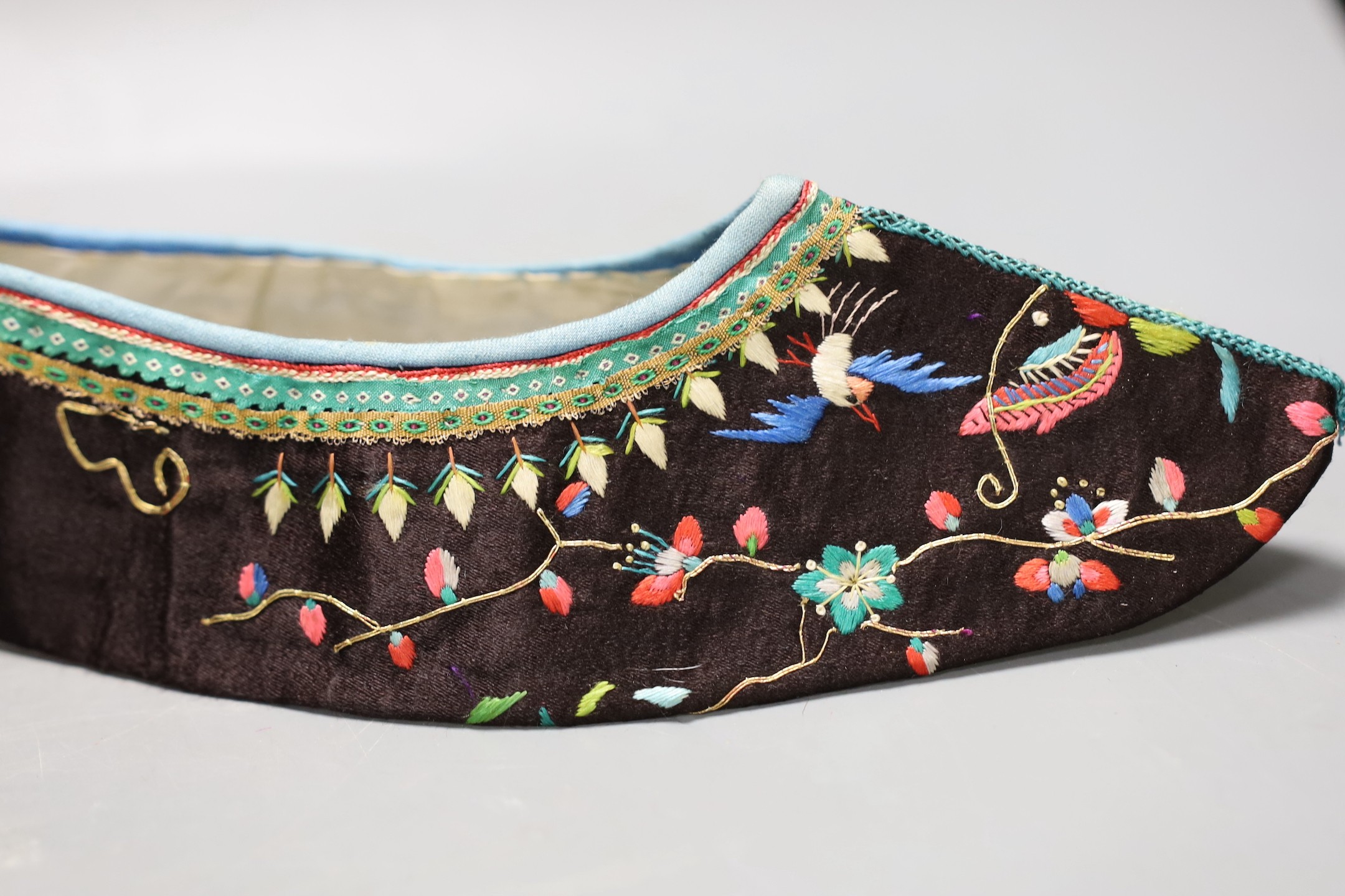A pair of Chinese embroidered silk shoes, upper section only